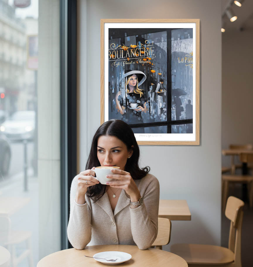 Woman sitting at a café table holding a coffee with