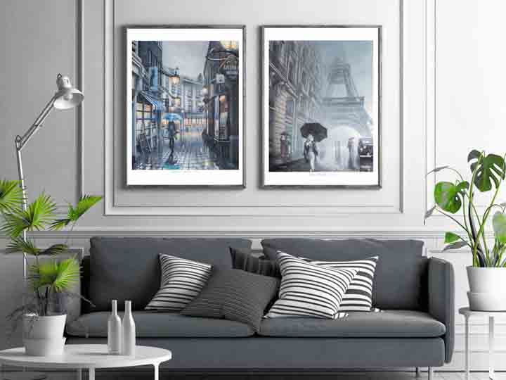 Gray sofa with decorative pillows in a living room setting with framed artwork on the wall.